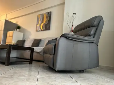 a living room with a couch and a reclining chair at Athens Cozy Apartment in Athens