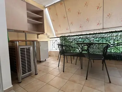 a kitchen with a table and chairs in a room at Athens Cozy Apartment in Athens