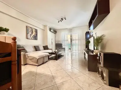 a living room with a couch and a tv at Athens Cozy Apartment in Athens