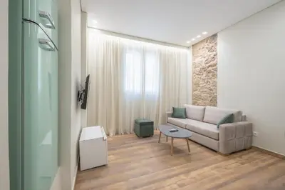 a living room with a couch and a table at Stone house in Athens in Athens