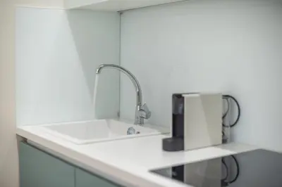 a kitchen counter with a sink and a faucet at Stone house in Athens in Athens