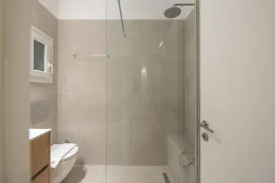 a bathroom with a shower and a toilet and a sink at Stone house in Athens in Athens