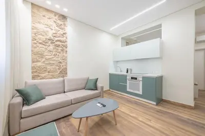 a living room with a couch and a table at Stone house in Athens in Athens