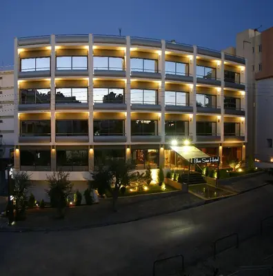 a large building with lights in front of it at Blue Sea Hotel Alimos in Athens