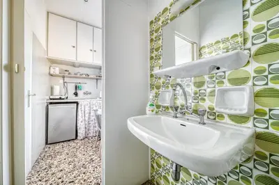 a bathroom with a sink and a kitchen at Acropolis View - Cozy Studio 4 Metro Neos Kosmos in Athens