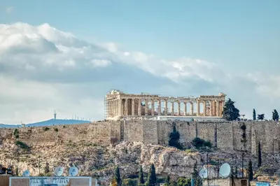 a building on top of a hill with a mountain at Acropolis View - Cozy Studio 4 Metro Neos Kosmos in Athens