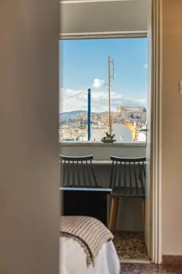 a view of a city from a window at Acropolis View - Cozy Studio 4 Metro Neos Kosmos in Athens