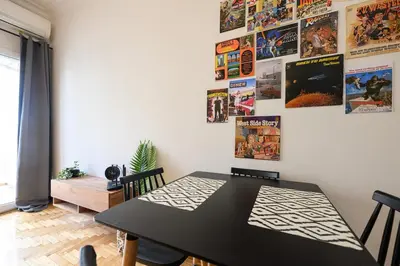 a dining room with a table and posters on the wall at Patision cinema apartment in Athens