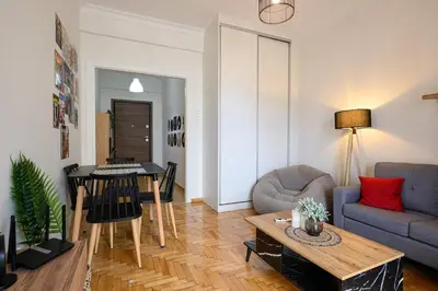 a living room with a couch and a table at Patision cinema apartment in Athens