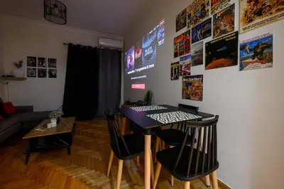 a room with a table and chairs in a living room at Patision cinema apartment in Athens