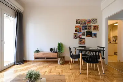 a dining room with a table and chairs at Patision cinema apartment in Athens