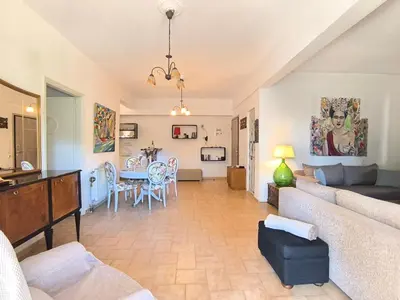 a living room with a couch and a table at Silver Paradeisi Apartment in Palaiá Fókaia