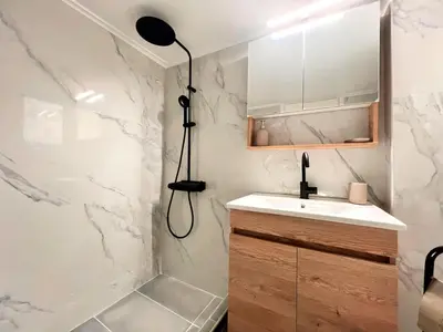 a bathroom with a shower and a sink and a lamp at Dafni 2Bdrm apartment in Neapoli by ΜΡS in Athens