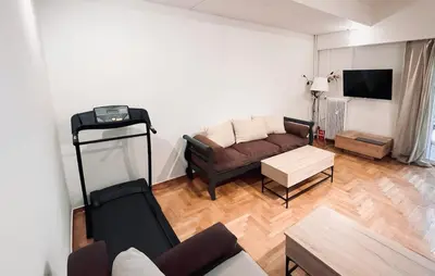 a living room with a couch and a table at Dafni 2Bdrm apartment in Neapoli by ΜΡS in Athens