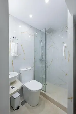 a bathroom with a toilet and a glass shower at Kynos Athens Studio in Athens