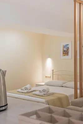 a bedroom with two beds with towels on them at Kynos Athens Studio in Athens