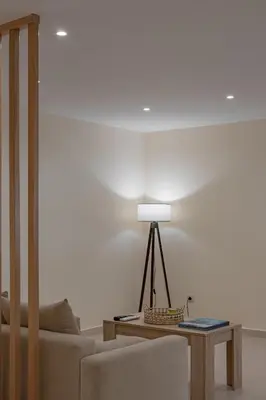 a living room with a couch and a table with a lamp at Kynos Athens Studio in Athens