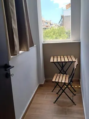 a small room with a table and a window at Family station in Athens