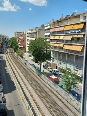 a view of a city street with train tracks at Family station in Athens