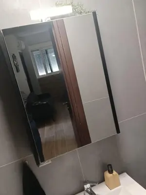 a mirror above a sink in a bathroom at Family station in Athens