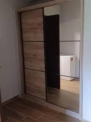 a room with a large closet with wooden doors at Family station in Athens