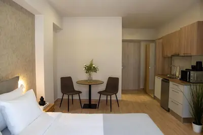 a bedroom with a bed and a table and chairs at Nuvia UrbanStay Piraeus Apartments in Piraeus