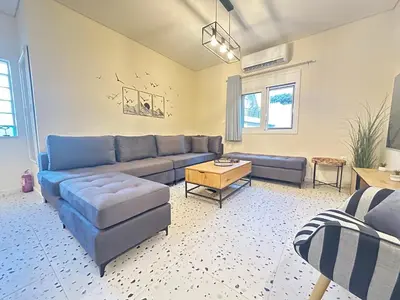 a living room with a blue couch and a table at Paloma Lux Retreat-15' to Central Athens in Athens