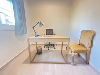 a desk with a lamp and a chair in a room at Paloma Lux Retreat-15' to Central Athens in Athens
