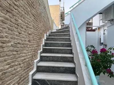 a set of stairs next to a brick wall at Paloma Lux Retreat-15' to Central Athens in Athens