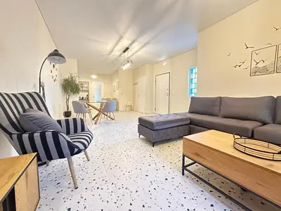 a living room with a couch and a table at Paloma Lux Retreat-15' to Central Athens in Athens