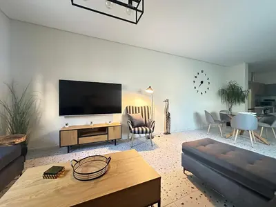a living room with a flat screen tv on a wall at Paloma Lux Retreat-15' to Central Athens in Athens
