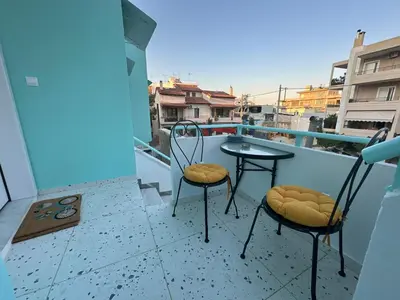 two chairs and a table on a balcony at Paloma Lux Retreat-15' to Central Athens in Athens