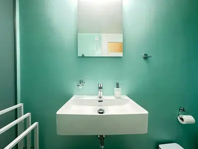 a bathroom with a white sink and a mirror at Paloma Lux Retreat-15' to Central Athens in Athens