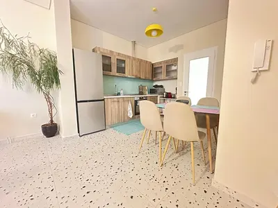 a kitchen with a table and chairs in a room at Paloma Lux Retreat-15' to Central Athens in Athens