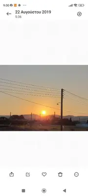 a picture of a sunset with a telephone pole at Αριάδνη στούντιο με θέα in Anavissos