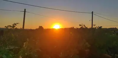 a sunset with the sun setting in the background at Αριάδνη στούντιο με θέα in Anavissos