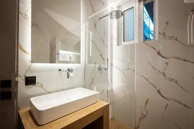 a bathroom with a white sink and a mirror at Nicolas Villa in Anavissos