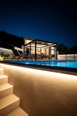 a house with a swimming pool at night at Nicolas Villa in Anavissos