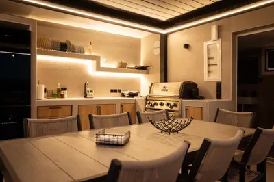 a kitchen with a table and chairs and a kitchen with a stove at Nicolas Villa in Anavissos