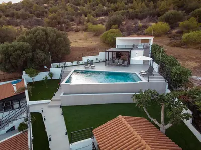an aerial view of a house with a swimming pool at Nicolas Villa in Anavissos