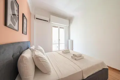 a bedroom with a bed with two towels on it at Veni Acropolis Museum 2Bd Apt in Athens