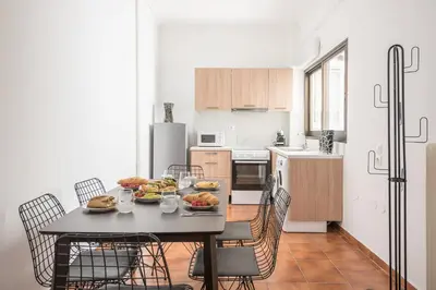a kitchen with a table with a plate of food on it at Veni Acropolis Museum 2Bd Apt in Athens