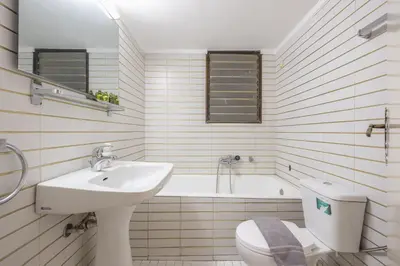 a bathroom with a sink and a toilet and a tub at Veni Acropolis Museum 2Bd Apt in Athens