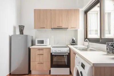 a kitchen with a refrigerator and a sink at Veni Acropolis Museum 2Bd Apt in Athens