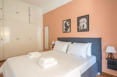 a bedroom with a bed with towels on it at Veni Acropolis Museum 2Bd Apt in Athens