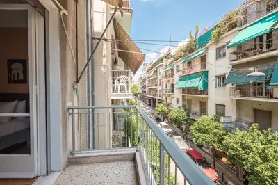 a balcony with a view of a street at Veni Acropolis Museum 2Bd Apt in Athens