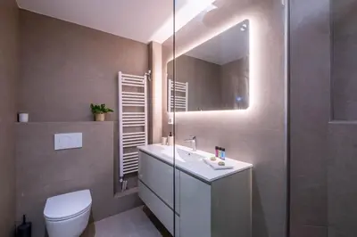 a bathroom with a sink and a toilet and a mirror at Stylish 2BR with Balcony, Northern Suburbs in Athens