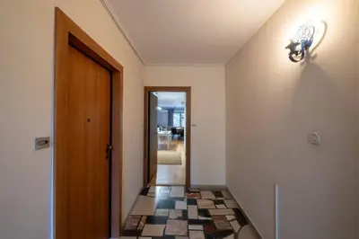 a hallway with a door and a tile floor at Stylish 2BR with Balcony, Northern Suburbs in Athens