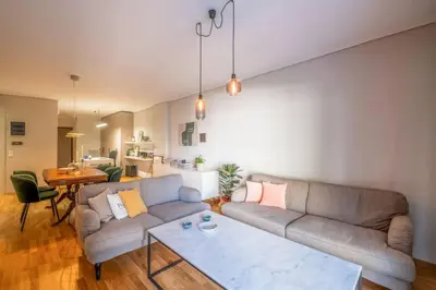a living room with a couch and a table at Stylish 2BR with Balcony, Northern Suburbs in Athens