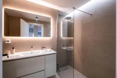 a bathroom with a sink and a shower with a mirror at Stylish 2BR with Balcony, Northern Suburbs in Athens